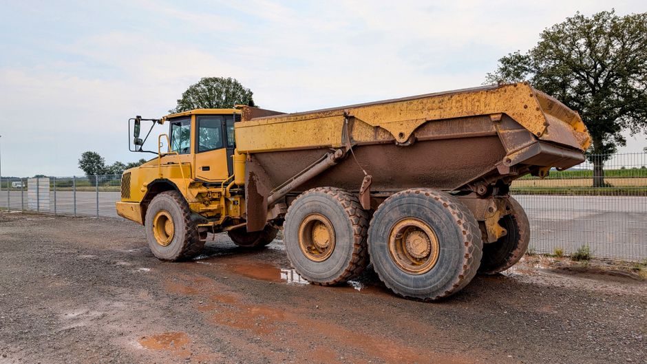 A robust yellow dump truck parked at a construction site in Pinneberg, Germany.