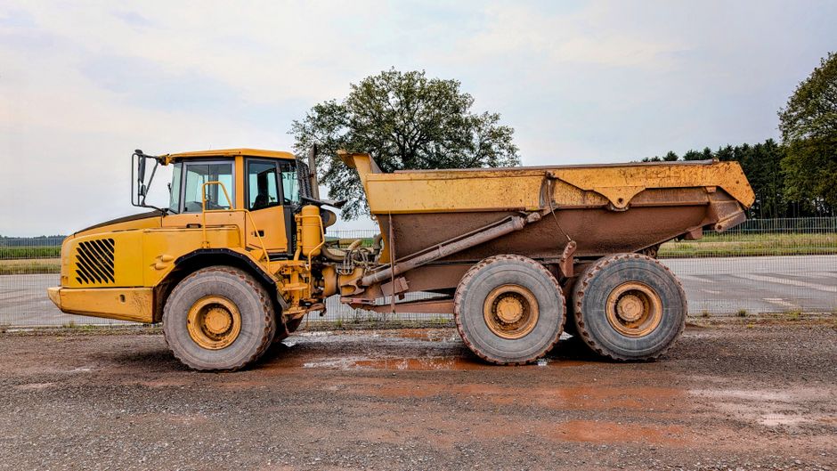 A large yellow dump truck parked on a construction site in Pinneberg.